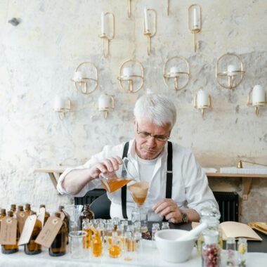 An experienced perfumist mixing natural ingredients for fragrance creation.