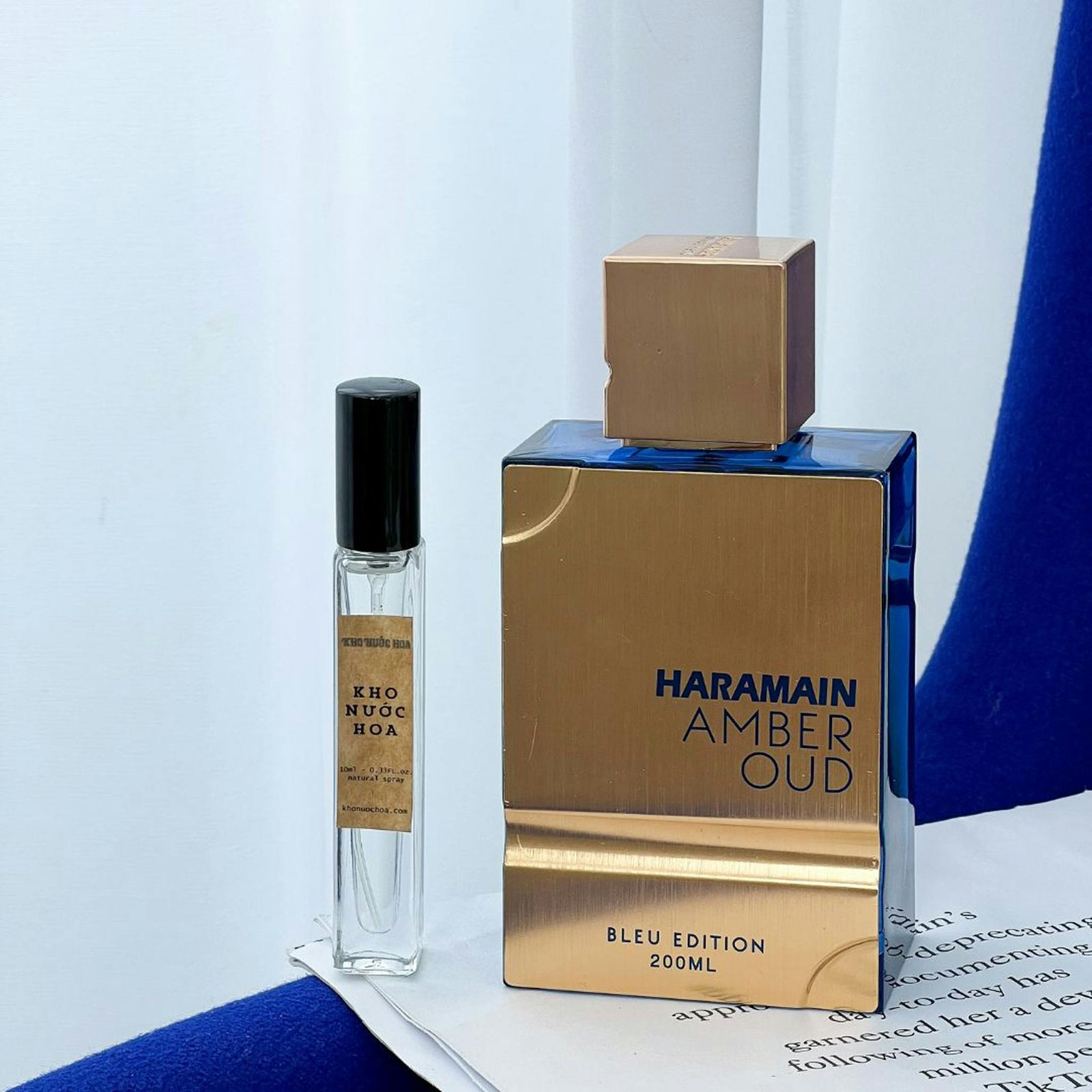 Elegant display of Haramain Amber Oud and Kho Nuoc Hoa perfume bottles with stylish minimalist background.