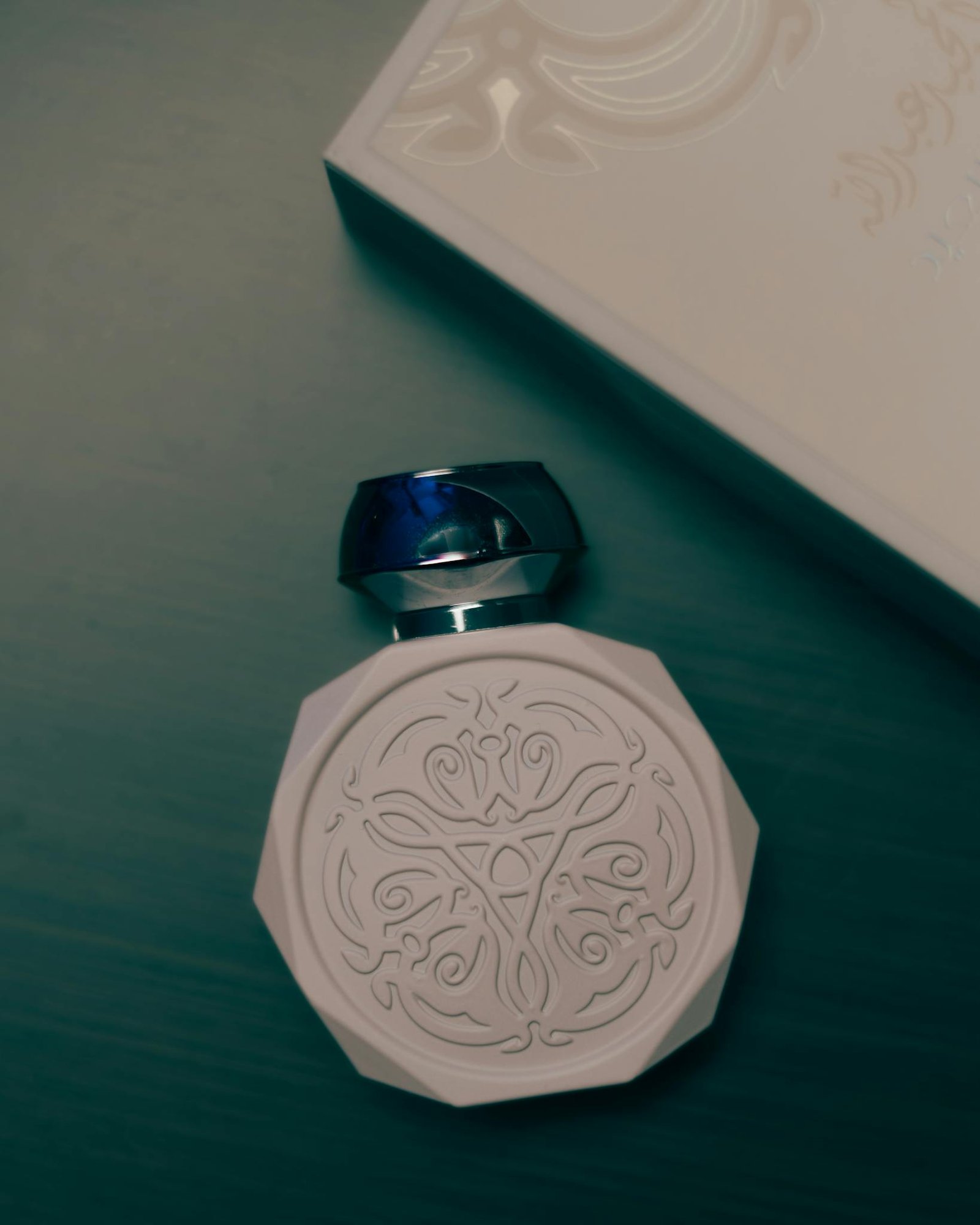 Sophisticated perfume bottle with intricate design, exuding elegance and luxury.